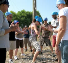A group supports a colleague during a ropes course team building activity in Sunnyvale California