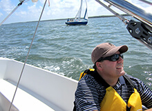 A sailing student soaks up the sun and lessons lerned during our sailing team building activity in Coral Gables Florida