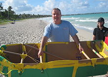 Participant shows off their seaworthy boat during our Build a Boat team building activity in Honolulu Hawaii