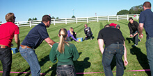 Teams take careful aim during the Sure Shot team building activity in Ann Arbor Michigan