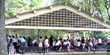 A large group gathers under a pavilion after debriefing our Pursuit team building activity in New Jersey