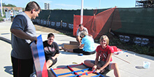 Group secures the foundation of their vessel during our Build a Boat team building activity in Cleveland Ohio