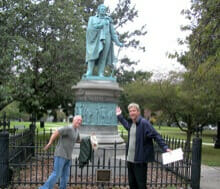 Colleagues pose next to statue during our GeoTrek team building activity in Rhode Island