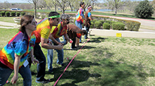 Group dressed in costume during the Sure Shot team building activity in Plano Texas