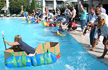 Group cheers on their teammates while racing boats in our Build a Boat team building activity in Salt Lake City Utah