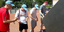 Team checks their GPS devices for the next location during our GeoTrek team building activities in Washington DC