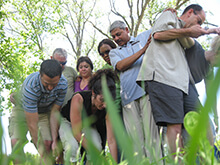 Group supports each other during our Tarp Turnover team building activity in Lake Geneva Wisconsin