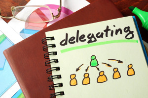 Notebook with delegating sign. Business concept.
